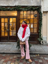 A lady wears a velour coat.